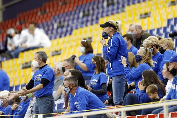 Montezuma fans react to a call in the first half of an 8-man high school football semifinal playoff game between Montezuma and Remsen St. Mary's at the UNI-Dome in Cedar Falls, Iowa, Thursday, Nov. 12, 2020. Capacity for state tournament games has been limited to 2400 and masks are required. (Liz Martin/The Gazette via AP)