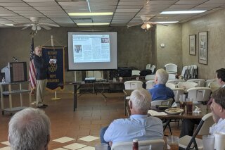 In this on Thursday, May 23, 2019 photo, Walter Hussman Jr., publisher of the statewide newspaper the Arkansas Democrat-Gazette, explains to members of the Hope, Arkansas Rotary Club how to access and use the paper's digital replica on an iPad in Hope, Ark. The newspaper will stop printing its daily paper by the end of the year and is distributing free iPads to all subscribers who transition to the daily digital version. (AP Photo/Hannah Grabenstein)