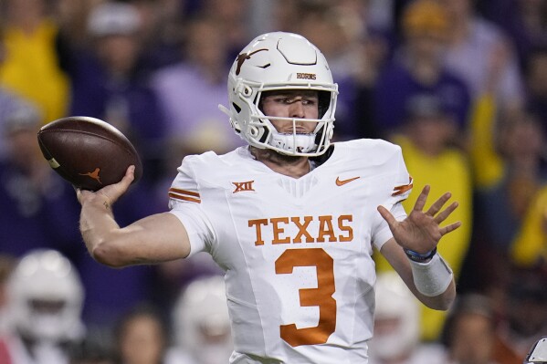 FILE - Texas quarterback Quinn Ewers throws a pass against TCU during the first half of an NCAA college football game, Saturday, Nov. 11, 2023, in Fort Worth, Texas. Ewers, the Texas native in his second season with the Longhorns after a year at Ohio State, is averaging 271 yards passing per game with 17 TDs and and five interceptions in his 10 games. (AP Photo/Julio Cortez, File)