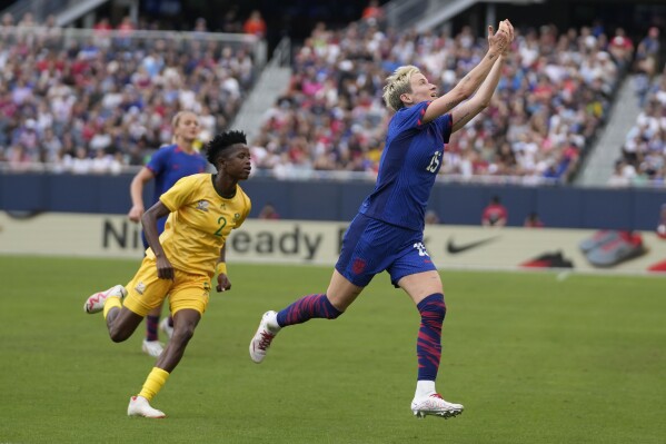 United States forward Megan Rapinoe, right, reaches up toward the ball as South Africa defender Lebogang Ramalepe chases her down during the first half of a soccer game Sunday, Sept. 24, 2023, in Chicago. (AP Photo/Erin Hooley)