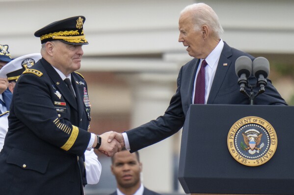 President Joe Biden, right, shakes hands with outgoing Joint Chiefs Chairman Gen. Mark Milley, during an Armed Forces Farewell Tribute in honor of Milley at Joint Base Myer–Henderson Hall, Friday, Sept. 29, 2023, in Fort Meyer, Va. Also held was an Armed Forces Hail in honor of Gen. CQ Brown, Jr., who the Senate confirmed as the next chairman of the Joint Chiefs of Staff. (AP Photo/Alex Brandon)