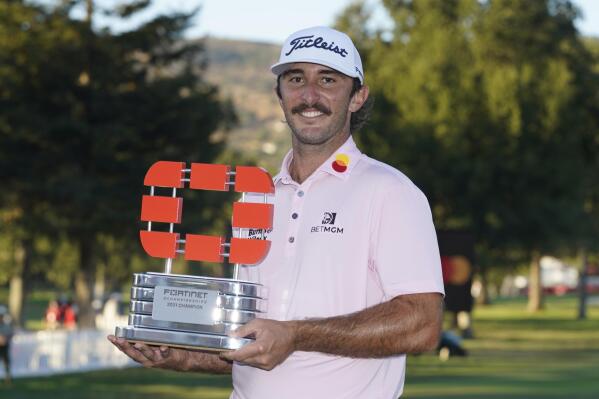 Max Homa poses with his trophy on the 18th green of the Silverado Resort North Course after winning the Fortinet Championship PGA golf tournament Sunday, Sept. 19, 2021, in Napa, Calif. (AP Photo/Eric Risberg)