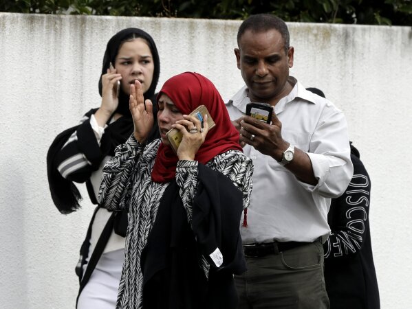 
              People wait outside a mosque in central Christchurch, New Zealand, Friday, March 15, 2019. Many people were killed in a mass shooting at a mosque, a witness said. (AP Photo/Mark Baker)
            