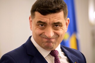 Presidential candidate George Simion waits to address members of the business community at the Chamber of Commerce and Industry of Romania, days ahead of the second round of the presidential election redo in Bucharest, Romania, Tuesday, May 13, 2025. (AP Photo/Vadim Ghirda)