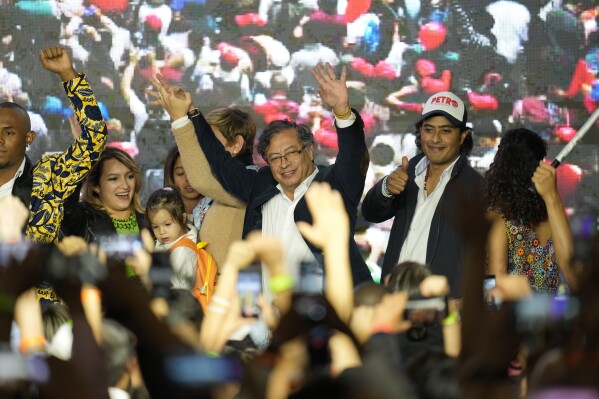 FILE - Presidential candidate Gustavo Petro, center, waves to supporters alongside his son Nicolas Petro Burgos, right, on election night in Bogota, Colombia, Sunday, May 29, 2022. Colombian police arrested Petro’s son Saturday, July 29, 2023, as part of a high-profile money laundering probe into funds he allegedly collected from convicted drug traffickers during last year’s presidential campaign. (AP Photo/Fernando Vergara, File)