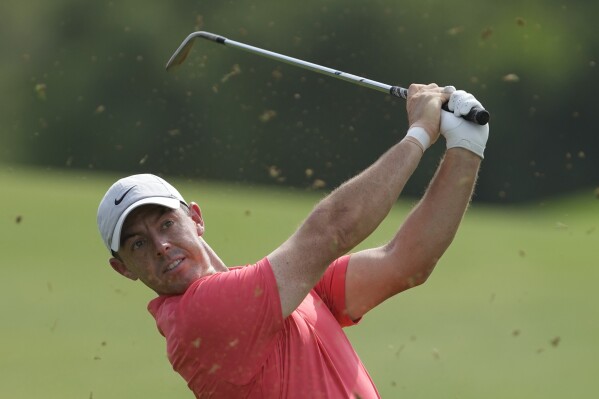 Rory McIlroy of Northern Ireland plays his second shot on the 3rd hole during the round one of the DP World Tour Championship golf tournament, in Dubai, United Arab Emirates, Thursday, Nov. 16, 2023. (AP Photo/Kamran Jebreili)