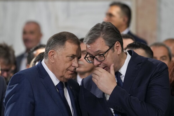 Bosnian Serb political leader Milorad Dodik, left, speaks with Serbian President Aleksandar Vucic during the prayer service for the All-Serbian Assembly in the St. Sava Serbian Orthodox temple in Belgrade, Serbia, Saturday, June 8, 2024. The All-Serbian Assembly carries the main message that Serbs, wherever they live, are one people, that they strive for the same goals. (AP Photo/Darko Vojinovic)