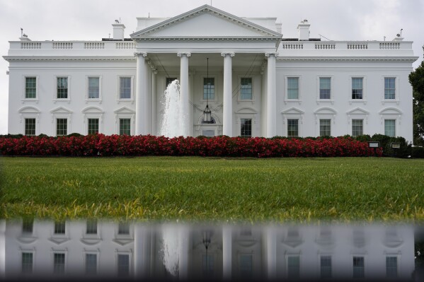 FILE - The White House is seen reflected in a puddle, Saturday, Sept. 3, 2022, in Washington. In a politically polarized nation, Americans seem to agree on one issue underlying the 2024 elections — a worry over the state of democracy and how the outcome of the presidential contest will affect its future. A poll from The Associated Press-NORC Center for Public Affairs Research found that 62% of adults say democracy in the U.S. could be at risk depending on who wins. That view is held by 72% of Democrats and 55% of Republicans, but for different reasons. (AP Photo/Carolyn Kaster, File)