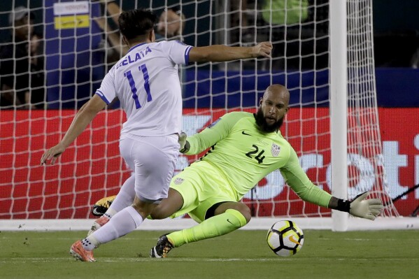FILE - United States' goalie Tim Howard (24) blocks a shot by El Salvador's Rodolfo Zelaya (11) during a CONCACAF Gold Cup quarterfinal soccer match in Philadelphia, July 19, 2017. Howard was elected to the U.S. National Soccer Hall of Fame on Saturday, Dec. 2, 2023, and will be inducted on May 4, 2024. (AP Photo/Matt Rourke, File)