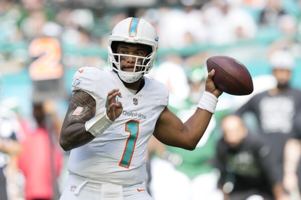 Miami Dolphins quarterback Tua Tagovailoa (1) aims a pass during the first half of an NFL football game against the New York Jets, Sunday, Dec. 17, 2023, in Miami Gardens, Fla. (AP Photo/Rebecca Blackwell)