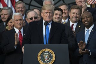 
              In this Dec. 20, 2017, photo, President Donald Trump, joined by Vice President Mike Pence, Speaker of the House Paul Ryan, R-Wis., and other members of congress, pauses as he speaks during an event on the South Lawn of the White House in Washington, to acknowledge the final passage of tax overhaul legislation by Congress. Two things can be true at once. President Donald Trump’s tax overhaul is slanted to the rich, as Democrats say and Republicans like to ignore. It also comes with tax cuts for average people, which Democrats bypass in slamming Trump’s “betrayal” of the middle class.(AP Photo/Carolyn Kaster)
            
