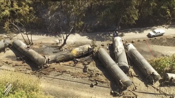 
              FILE - In this June 6, 2016, file aerial video image taken from a drone, crumpled oil tankers lie beside the railroad tracks after a fiery train derailment that prompted evacuations from the tiny Columbia River Gorge town of Mosier, Ore. The Trump administration vastly understated the potential benefits of installing more advanced brakes on trains that haul explosive fuels when it cancelled a requirement for railroads to begin using the equipment. A government analysis used by the administration to justify the cancellation omitted up to $117 million in potential reduced damages from using electronic brakes. Department of Transportation officials acknowledged the error after it was discovered by The Associated Press during a review of federal documents but said it would not have changed their decision. (Brent Foster via AP, file)
            