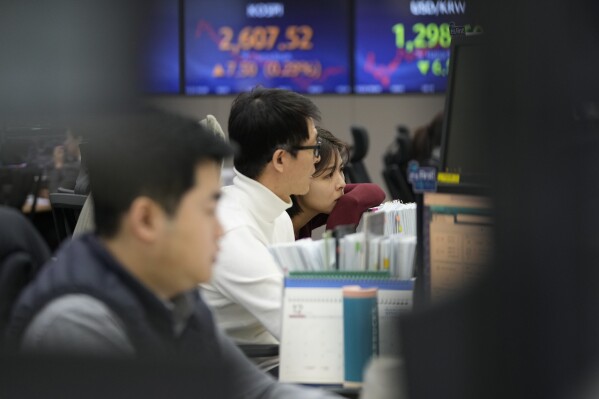 Currency traders watch monitors at the foreign exchange dealing room of the KEB Hana Bank headquarters in Seoul, South Korea, Friday, Dec. 22, 2023. Shares were mostly higher in Asia on Friday after several strong profit reports helped Wall Street claw back most of its sharp loss from day before. (AP Photo/Ahn Young-joon)