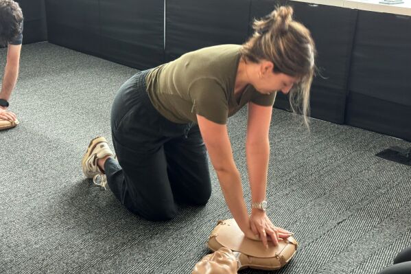 Staff member practicing hands-only CPR