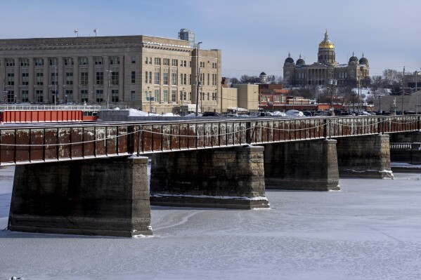 The Iowa State Capitol building is visible beyond a frozen Des Moines River the morning of the Iowa State Caucus in Des Moines, Iowa, Monday, Jan. 15, 2024. (AP Photo/Andrew Harnik)