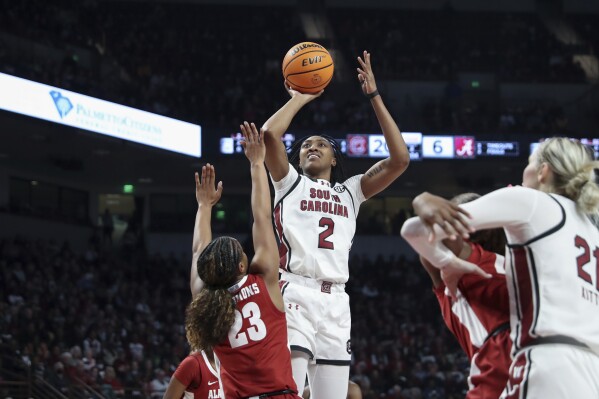 South Carolina forward Ashlyn Watkins (2) scores over Alabama guard Jessica Timmons (23) during the first half of an NCAA college basketball game Thursday, Feb. 22, 2024, in Columbia, S.C. (AP Photo/Artie Walker Jr.)