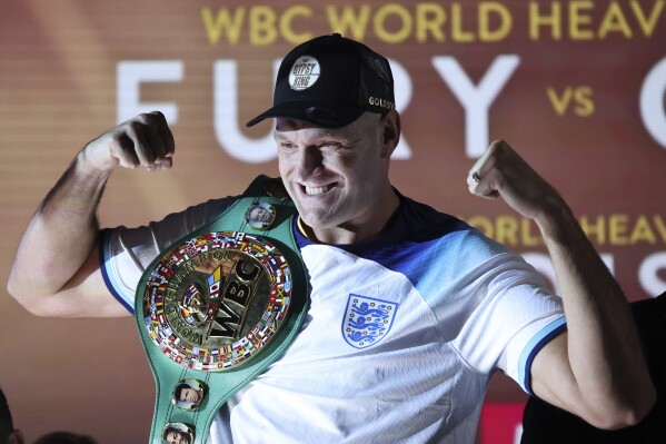 FILE - WBC heavyweight boxing champion Tyson Fury poses with his championship belt after the official weigh-in for his fight against Derek Chisora, in London, Friday Dec. 2, 2022. Boxing heavyweight champion Tyson Fury and former UFC heavyweight champion Francis Ngannou will fight in a boxing bout Oct. 28 in Saudi Arabia, the promoter Top Rank announced Tuesday, July 11, 2023. (AP Photo/Ian Walton, File)