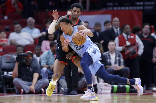 Memphis Grizzlies guard Desmond Bane, front, drives around Houston Rockets guard Kevin Porter Jr., back, during the first half of an NBA basketball game Wednesday, March 1, 2023, in Houston. (AP Photo/Michael Wyke)