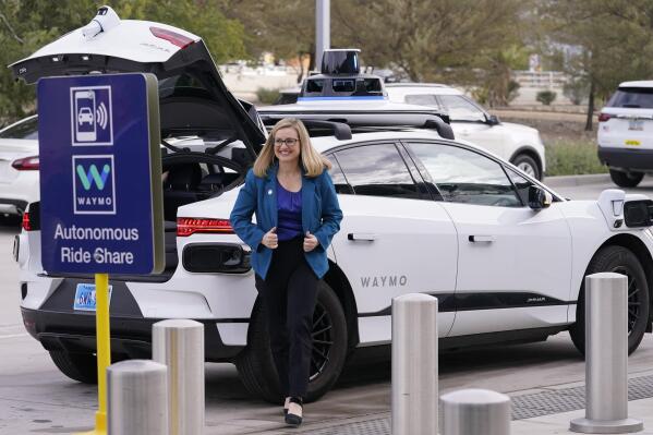 Phoenix Mayor Kate Gallego arrives in a self-driving vehicle, Friday, Dec. 16, 2022, at the Sky Harbor International Airport Sky Train facility in Phoenix. Mayor Gallego announced Friday that Sky Harbor will be the first airport to have self-driving, ride-hailing service Waymo available. A test group has been using Waymo vehicles from the airport's sky train to downtown Phoenix since early November.(AP Photo/Matt York)
