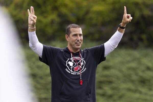 Wisconsin NCAA college football head coach Luke Fickell gestures on the first day of training camp in Platteville, Wisc., Wednesday, Aug. 2, 2023. (Samantha Madar/Wisconsin State Journal via AP)