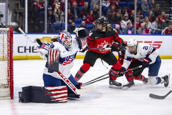 United States goaltender Nicole Hensley (29) stops a Canada shot during the second period of a Rivalry Series hockey game Wednesday, Feb. 7, 2024, in Saskatoon, Saskatchewan. (Liam Richards/The Canadian Press via AP)