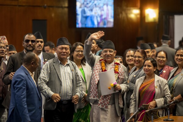 Nepalese Prime Minister Pushpa Kamal Dahal waves to media after winning a vote of confidence in parliament in Kathmandu, Nepal, Monday, May 20, 2024. Dahal will continue leading his shaky governing coalition after winning his fourth vote of confidence in two years on Monday. (AP Photo/Niranjan Shrestha)