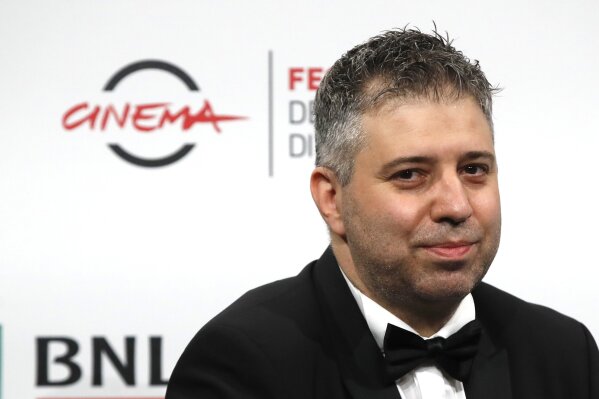 Director Evgeny Afineevsky poses for photographers during the photo call for the movie "Francesco", at the Rome Film Festival, in Rome, Wednesday, Oct. 21, 2020. (AP Photo/Alessandra Tarantino)