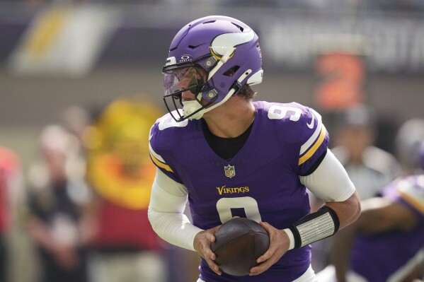 Minnesota Vikings quarterback J.J. McCarthy (9) looks to hand off during the first half of an NFL football game against the Las Vegas Raiders, Saturday, Aug. 10, 2024, in Minneapolis. (AP Photo/Charlie Neibergall)