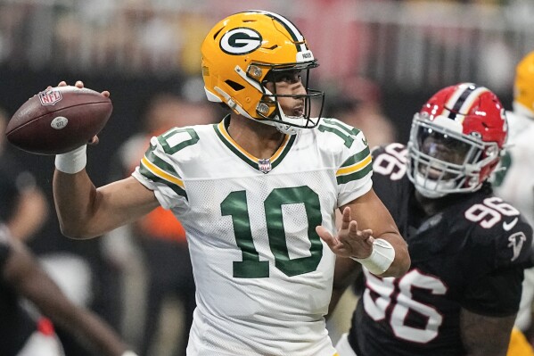 Green Bay Packers quarterback Jordan Love (10) passes the ball in the pocket as Atlanta Falcons defensive end Zach Harrison (96) defends during the second half of an NFL football game, Sunday, Sept. 17, 2023, in Atlanta. (AP Photo/Brynn Anderson)