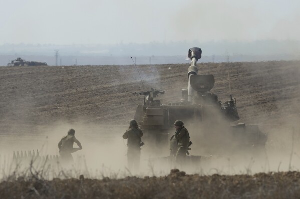 An Israeli mobile artillery unit fired a shell from southern Israel towards the Gaza Strip, in a position a near the Israel Gaza border, Israel, Wednesday, Oct. 11, 2023. (AP Photo/Erik Marmor)