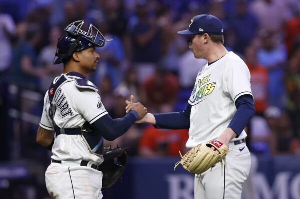 Tampa Bay Rays relief pitcher Pete Fairbanks celebrates with catcher Christian Bethancourt after the Rays defeated the Baltimore Orioles 3-0 in a baseball game Friday, July 21, 2023, in St. Petersburg, Fla. (AP Photo/Scott Audette)