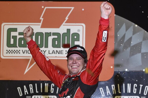 Erik Jones celebrates his victory after a NASCAR Cup Series auto race on Sunday, Sept. 1, 2019, at Darlington Raceway in Darlington, S.C. Jones held off Joe Gibbs Racing teammate Kyle Busch to win the rain-delayed Southern 500 that ended early Monday morning. (AP Photo/Richard Shiro)