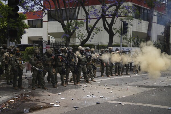 Border Patrol personnel deploy tear gas during a demonstration over the dozens detained in an operation by federal immigration authorities a day earlier in Paramount section of Los Angeles Saturday, June 7, 2025. (AP Photo/Eric Thayer)