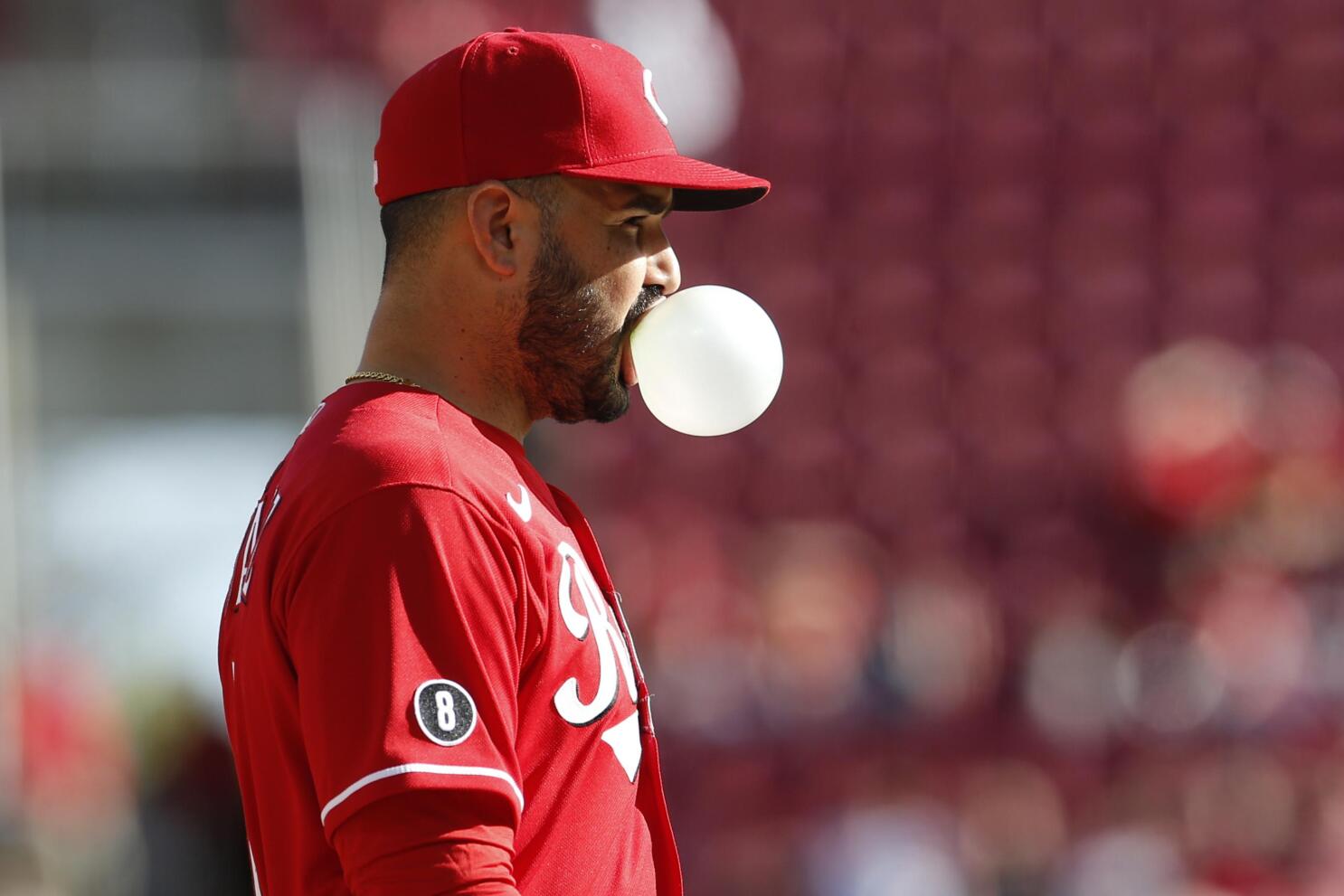 Cincinnati Reds' Tyler Stephenson blows a bubble as he runs the bases  during a baseball game