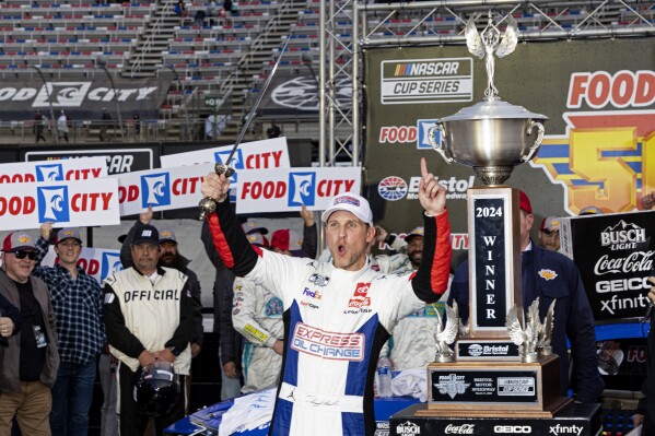 Denny Hamlin celebrates winning a NASCAR Cup Series auto race, Sunday, March 17, 2024, in Bristol, Tenn. (AP Photo/Wade Payne)