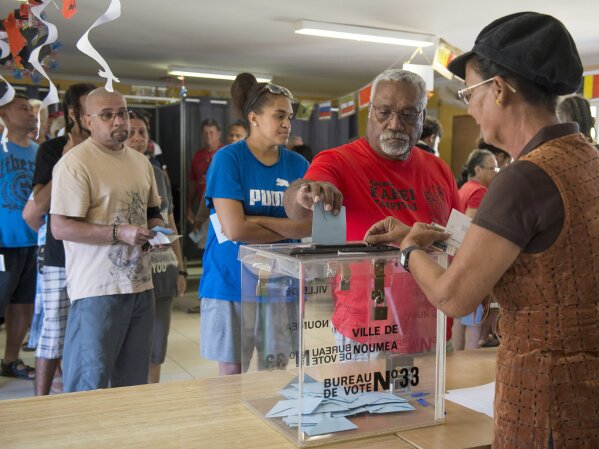 
              A man casts his vote at a polling station in Noumea, New Caledonia, as part of an independence referendum, Sunday, Nov. 4, 2018. Voters in New Caledonia are deciding whether the French territory in the South Pacific should break free from the European country that claimed it in the mid-19th century. (AP Photo/Mathurin Derel)
            