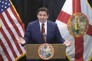 FILE - Florida Gov. Ron DeSantis delivers remarks during a press conference at the Central Florida Tourism Oversight District headquarters at Walt Disney World, in Lake Buena Vista, Fla., Thursday, Feb. 22, 2024. The University of Florida is eliminating its chief diversity officer position, Friday, March 1, scrapping the program’s staff jobs and halting any contracts involving the subject because of a new law passed last year by the Republican-dominated state Legislature. (Joe Burbank/Orlando Sentinel via AP, File)