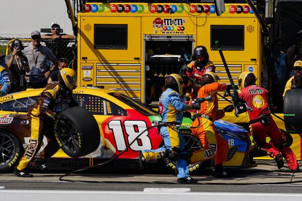 The pit crew for Kyle Busch services the car in a stop during a NASCAR Cup Series auto race at Pocono Raceway, Sunday, July 24, 2022 in Long Pond, Pa. (AP Photo/Matt Slocum)