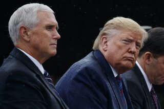 In this Sept. 30, 2019 photo, Vice President Mike Pence and President Donald Trump participate in an Armed Forces welcome ceremony for the new chairman of the Joint Chiefs of Staff, Gen. Mark Milley, at Joint Base Myer-Henderson Hall, Va.  Aides to Vice President Mike Pence are disputing a whistleblower’s characterization of his decision not to attend Ukrainian President Volodymyr Zelenskiy’s inauguration earlier this year. And they say he never discussed President Donald Trump’s potential Democratic rival Joe Biden in their repeated conversations.  (AP Photo/Evan Vucci)