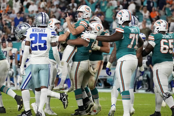 Miami Dolphins place kicker Jason Sanders, center, celebrates after kicking the game winning field goal during the second half of an NFL football game against the Dallas Cowboys, Sunday, Dec. 24, 2023, in Miami Gardens, Fla. (AP Photo/Rebecca Blackwell)