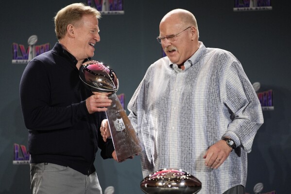 NFL commissioner Roger Goodell hands Kansas City Chiefs head coach Andy Reid the Vince Lombardi Trophy during a news conference following the Super Bowl 58 NFL football game Monday, Feb. 12, 2024, in Las Vegas. (AP Photo/John Locher)