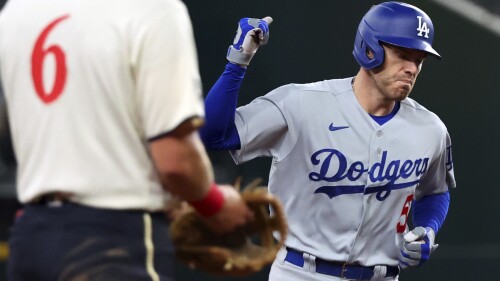 Los Angeles Dodgers' Freddie Freeman (5) pumps his fist as he runs the bases after a home run in the fifth inning against the Texas Rangers during a baseball game Friday, July 21, 2023, in Arlington, Texas. (AP Photo/Richard W. Rodriguez)