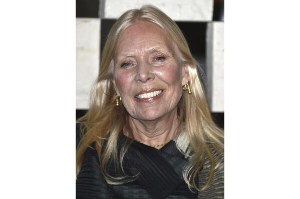 FILE- Joni Mitchell arrives to the Hammer Museum's "Gala In The Garden" taken in Los Angeles on Oct. 10, 2014. Chaka Khan, Cyndi Lauper and Beck and many others will be among those performing in tribute to Joni Mitchell when she’s honored as the 2022 MusiCares Person of the Year by the Recording Academy (Photo by John Shearer/Invision/AP, File)