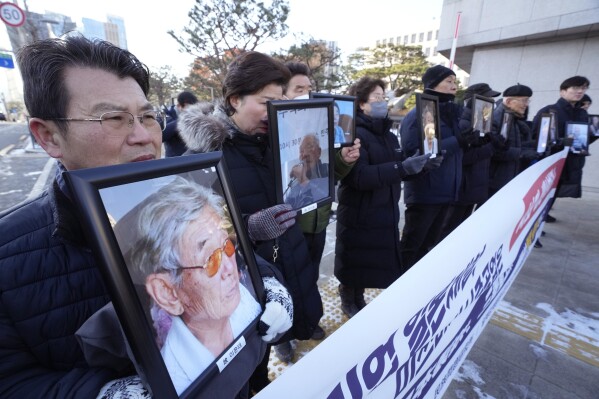 Family members of forced labor victims during the Japan's colonial period, arrive at the Supreme Court in Seoul, South Korea, Thursday, Dec. 21, 2023. South Korea’s top court ordered two Japanese companies to financially compensate more of their wartime Korean workers for forced labor, as it sided Thursday with its contentious 2018 verdicts that caused a huge setback in relations between the two countries. (AP Photo/Ahn Young-joon)