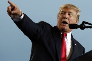 In this Oct. 11, 2017, photo, President Donald Trump speaks about tax reform during an event at the Harrisburg International Airport in Middletown, Pa. Trump's tax overhaul package is getting resistance from an unusual alliance of interests opposed to his plans to scrap the federal deduction for state and local taxes. (AP Photo/Alex Brandon)