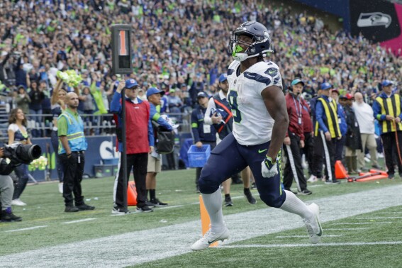 Seattle Seahawks running back Kenneth Walker III celebrates after scoring during the second half of an NFL football game against the Carolina Panthers Sunday, Sept. 24, 2023, in Seattle. (AP Photo/John Froschauer)