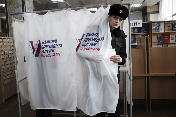 A student of the Maritime State University named after admiral Gennady Nevelskoy leaves a voting booth at a polling station during a presidential election in the Pacific port city of Vladivostok, 6,418 km (3,566 miles) east of Moscow, Russia, Friday, March 15, 2024. Voters in Russia headed to the polls for a presidential election that was all but certain to extend President Vladimir Putin's rule after he clamped down on dissent. (AP Photo)