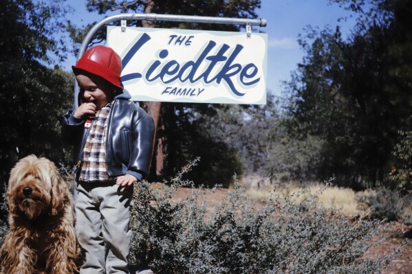 This photo provided by Michael Liedtke shows him outside a cabin in Big Bear, Calif., with his grandfather's dog, Pudge, in 1963. (James Liedtke via AP)