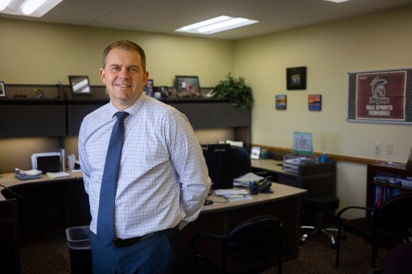 This image provided by Idaho Education News shows Jefferson School District Super Intendent Chad Martin posing for a photo in Rigby, Idaho on Wednesday, Feb. 5, 2025. (John Roark/Idaho Education News via AP)