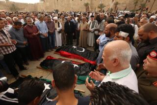 FILE - Mourners pray for fighters killed in airstrikes by warplanes of Field Marshal Khalifa Hifter's forces, in Tripoli, Libya, April 24, 2019, as officials in Libya's U.N.-backed administration said they plan to present evidence to Moscow of Russian mercenaries from the Russian private security contractor Wagner Group fighting alongside their adversary, the forces of Hifter, in their country's war. Human Rights Watch on Tuesday, May 31, 2022, called for the International Criminal Court to investigate allegations of the use of landmines in 2019 by Russian paramilitaries fighting in Libya. (AP Photo/Hazem Ahmed, File)